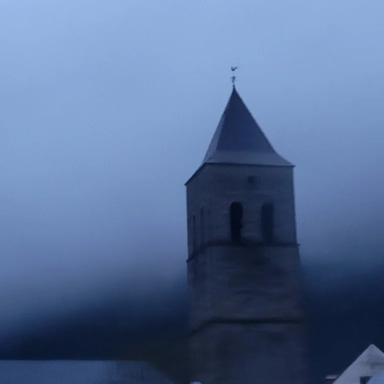 A stone tower emerging from blue mist, the official Tower artwork.